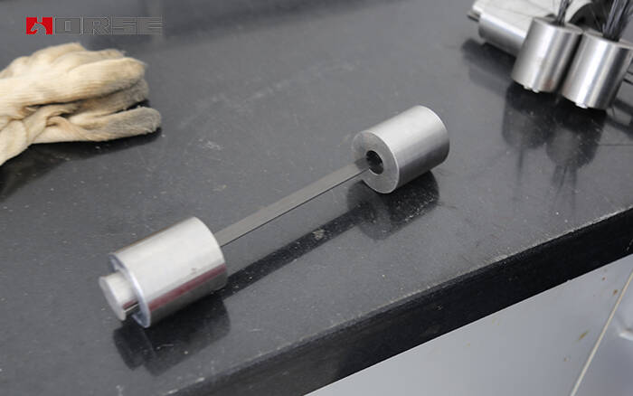 1601015193250724.jpg Testing of tensile properties of carbon fiber reinfroced polymer(CFRP) strip.jpg